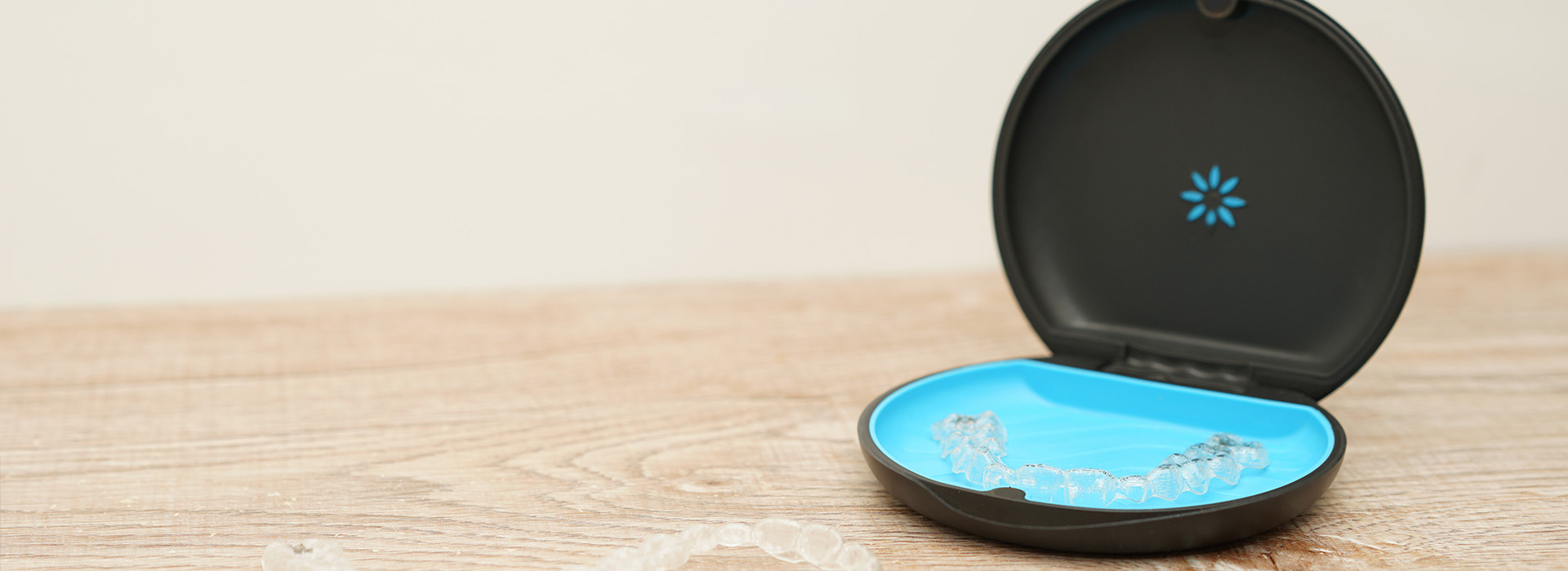 An open blue box with a black lid on a white surface.